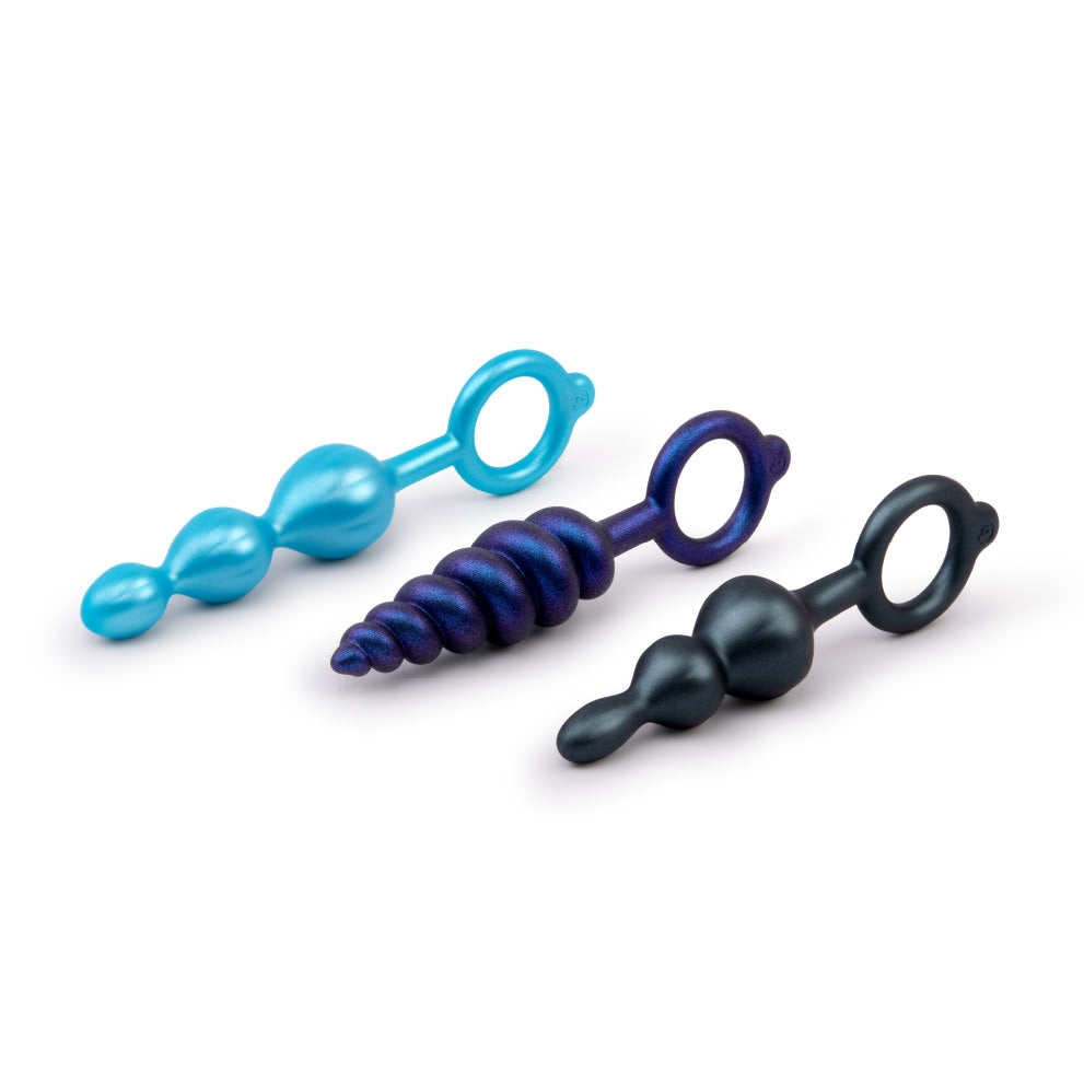 Three silicone anal plugs in blue, purple, and dark gray with beaded and spiral textures.