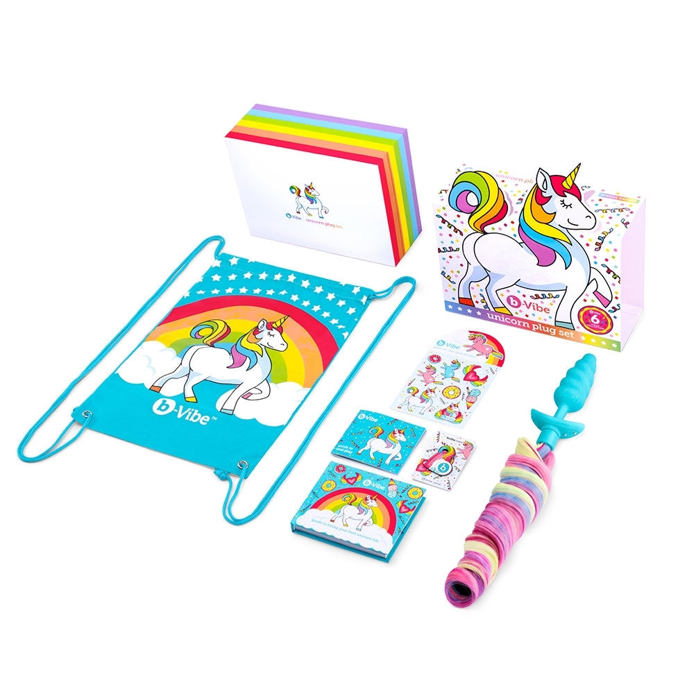A vibrating unicorn anal plug set with a rainbow tail and unicorn-themed accessories.