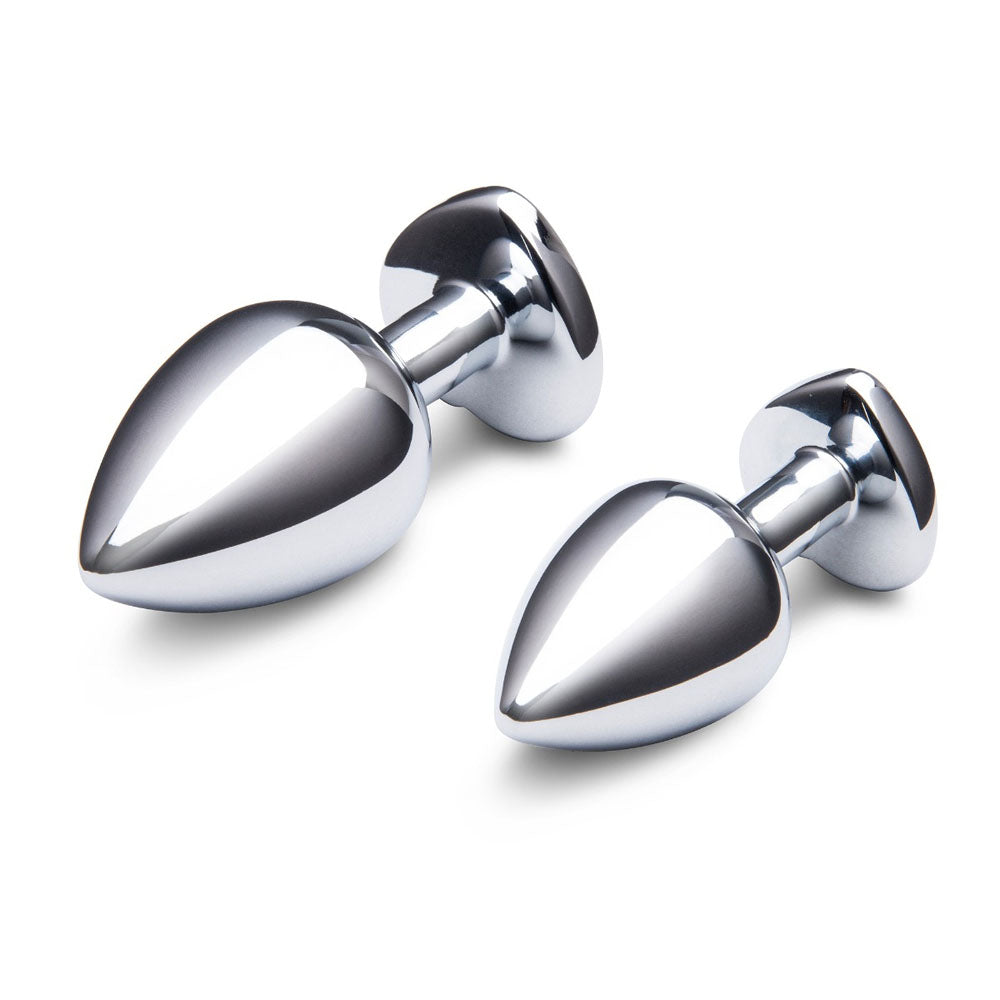 Two polished metal butt plugs with heart-shaped bases.