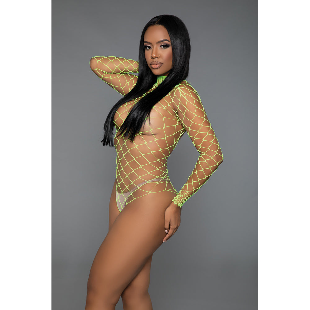 A woman wears a neon green wide fishnet long-sleeve bodystocking.