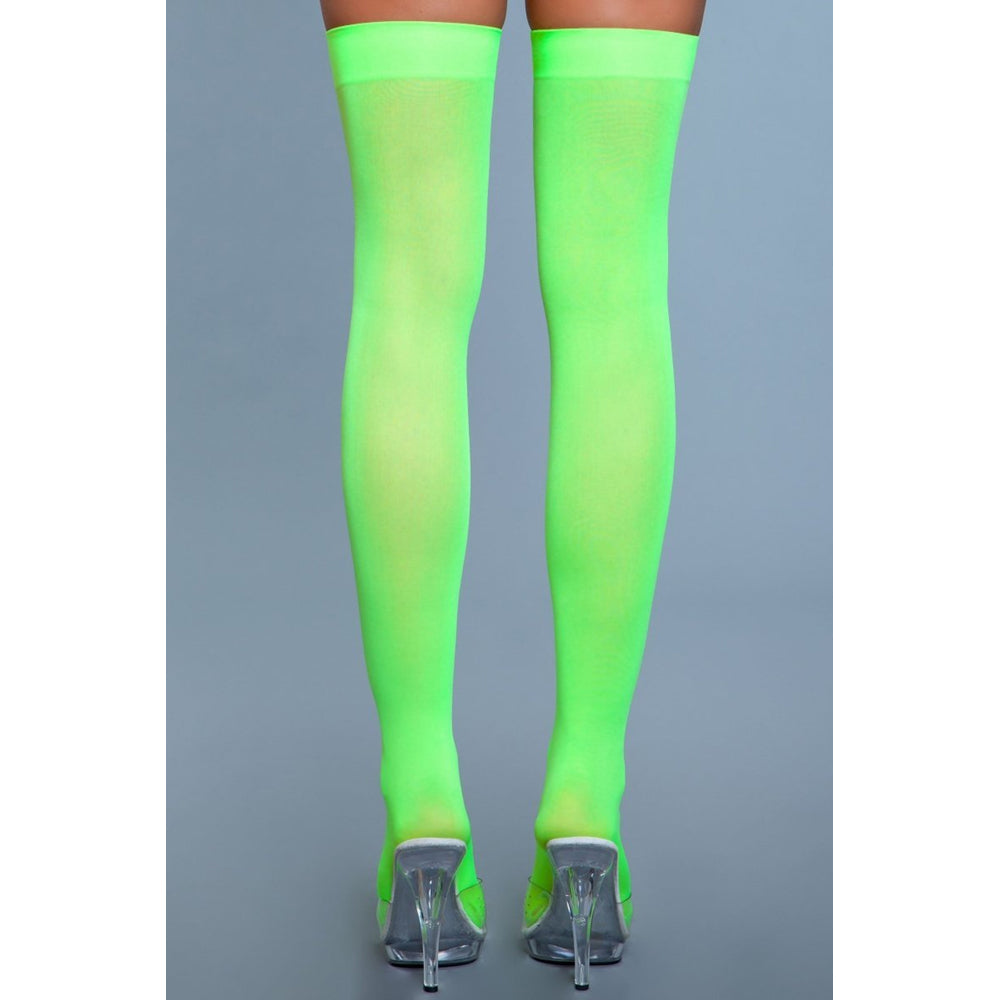 Neon green opaque nylon thigh-high stockings with clear heels.
