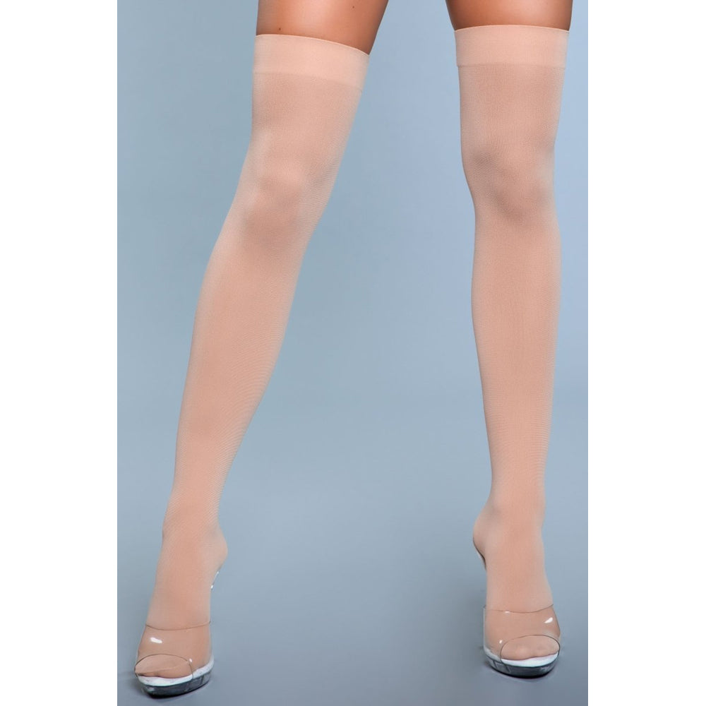 Opaque nude nylon thigh-high stockings with a solid band.
