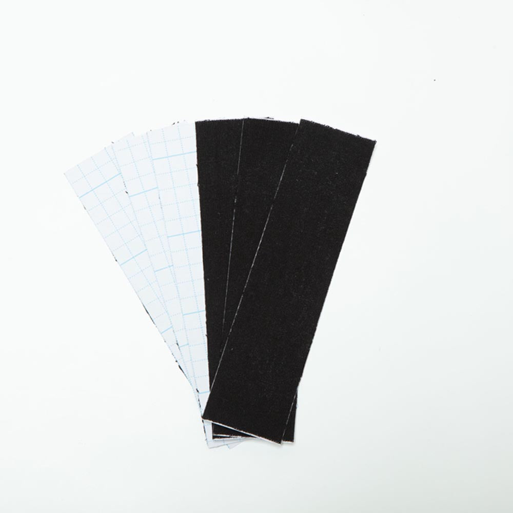 Black waterproof adhesive breast lift tape strips with grid backing.