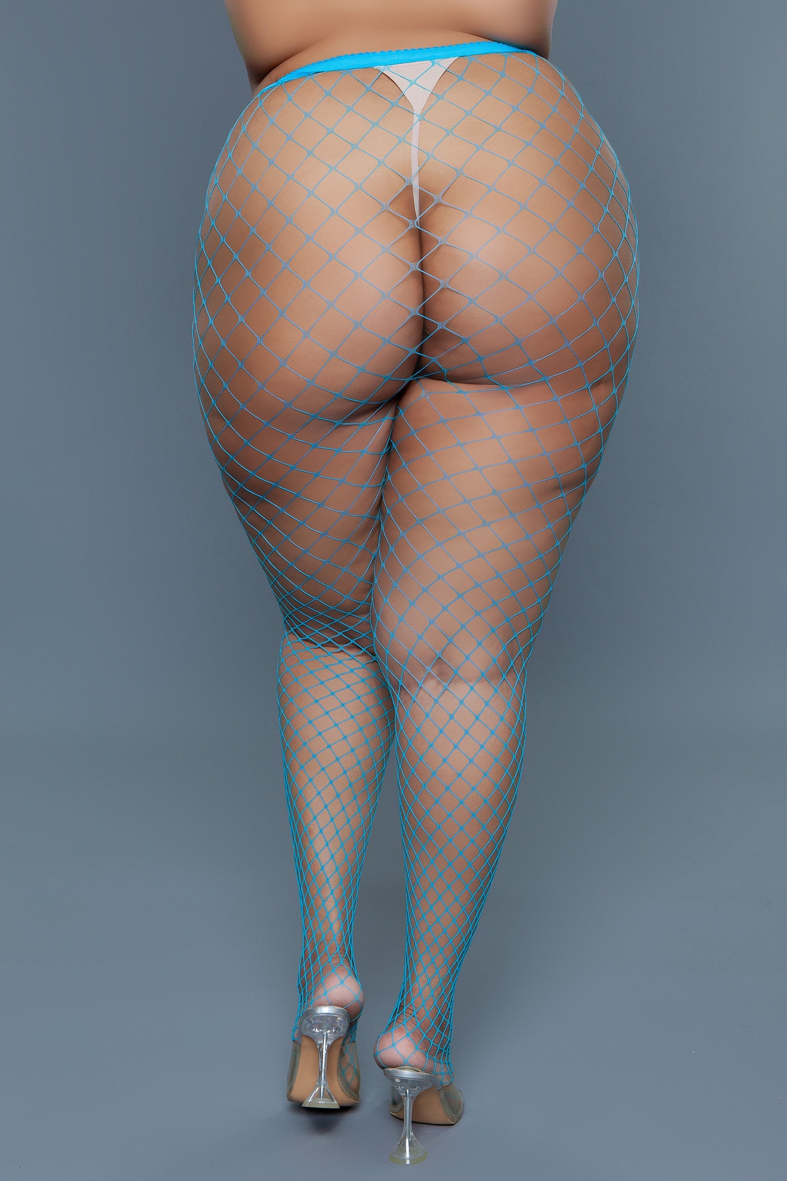 Rear view of a model wearing turquoise oversized fishnet pantyhose with high heels.