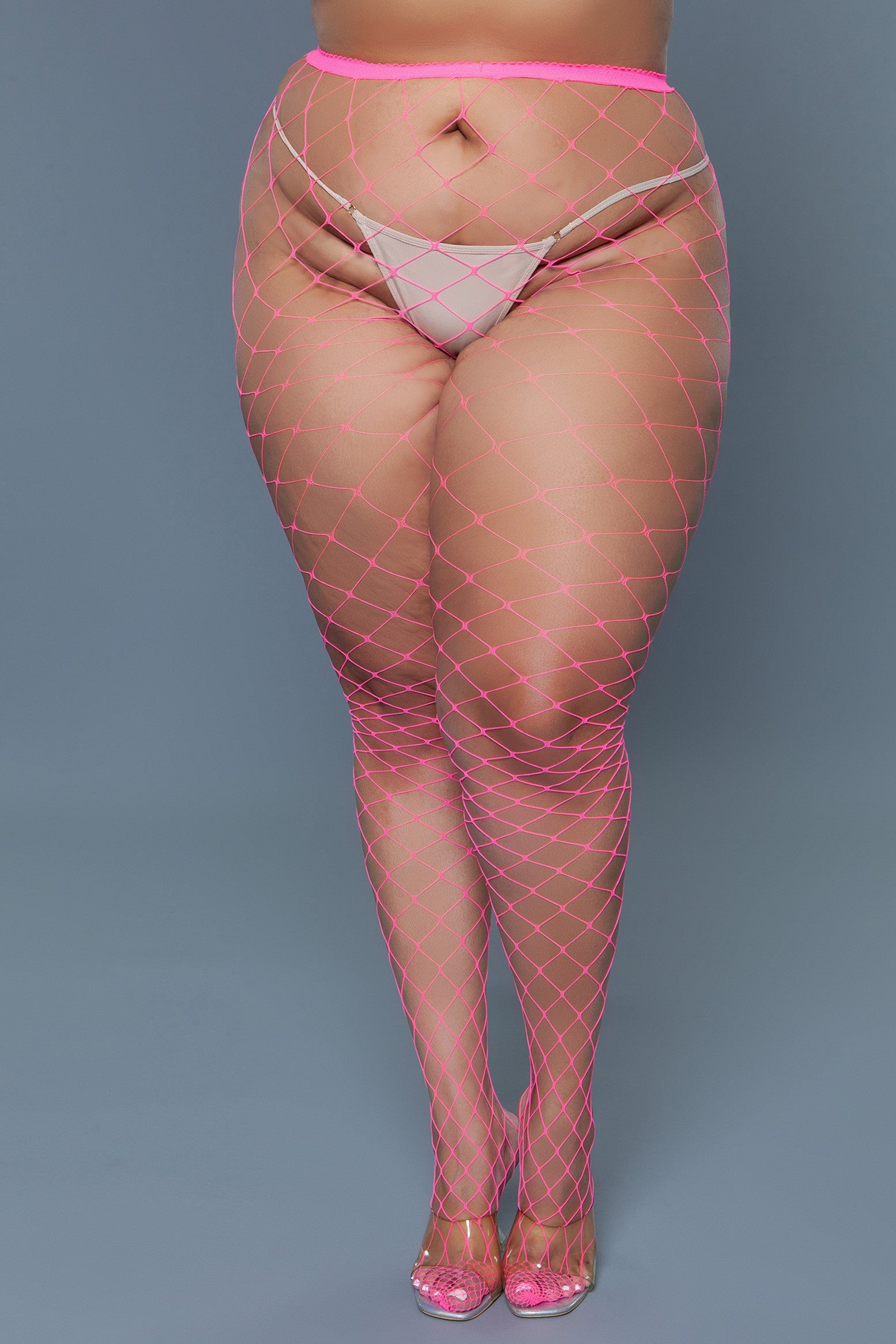 Oversized hot pink fishnet pantyhose with a thong.