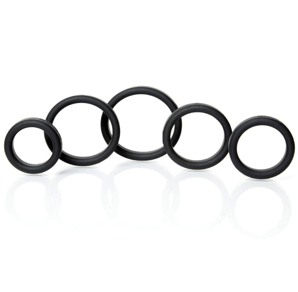 Five black silicone rings of varying sizes are arranged in a row.