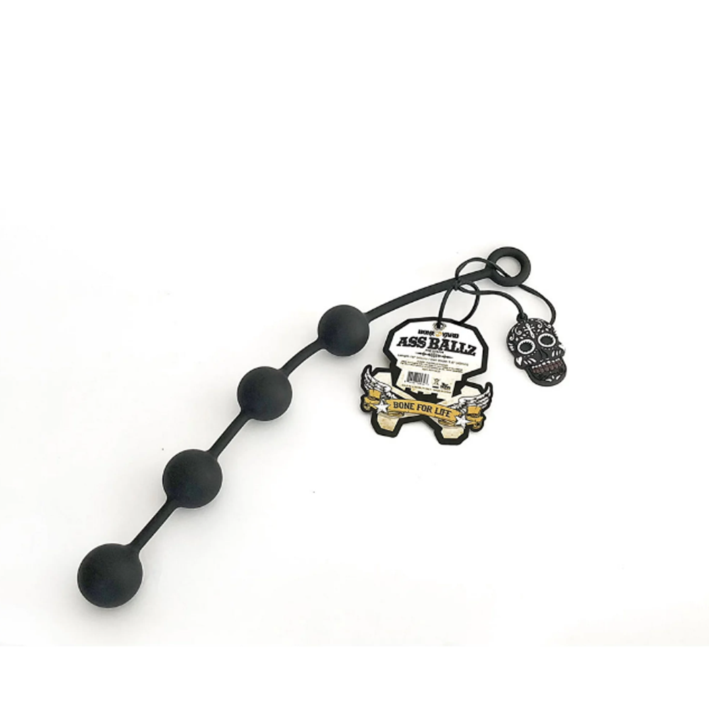 Black silicone anal bead chain with a skull charm and tag.