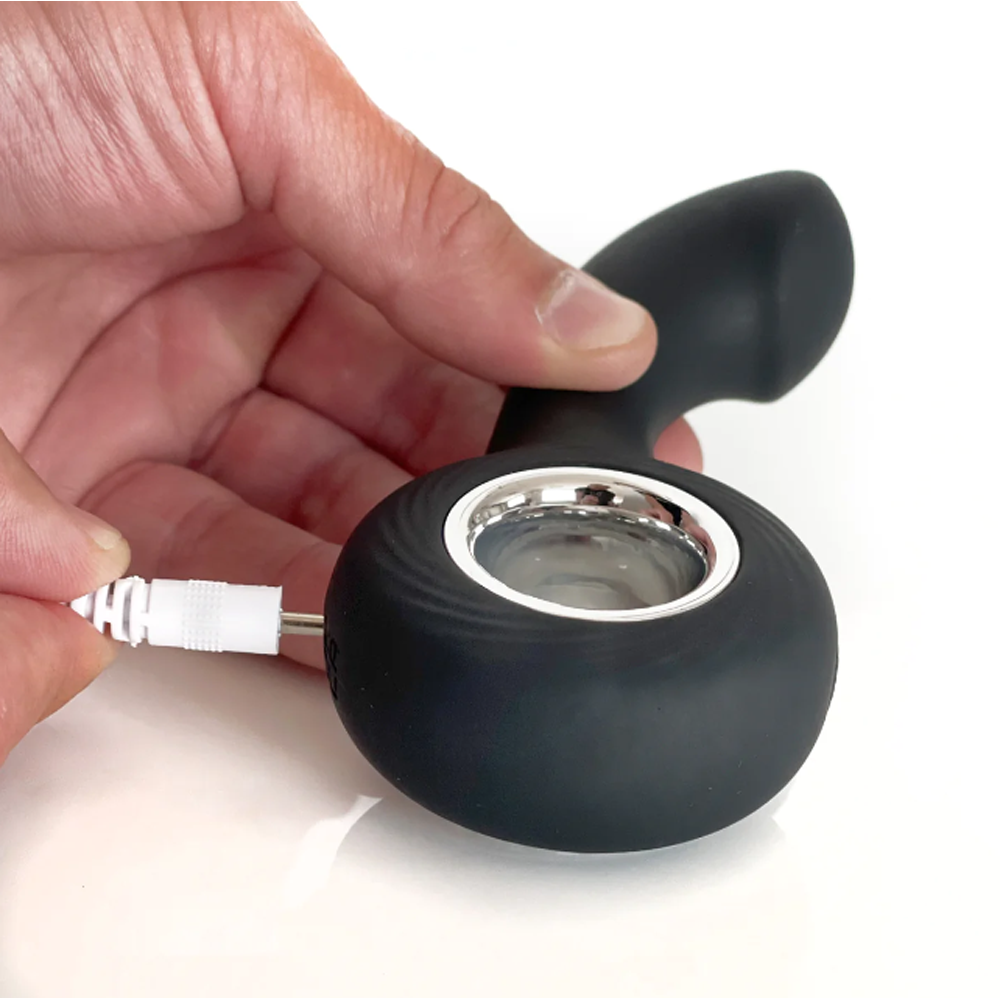 A black rechargeable silicone P-spot vibrator with a charging cable.