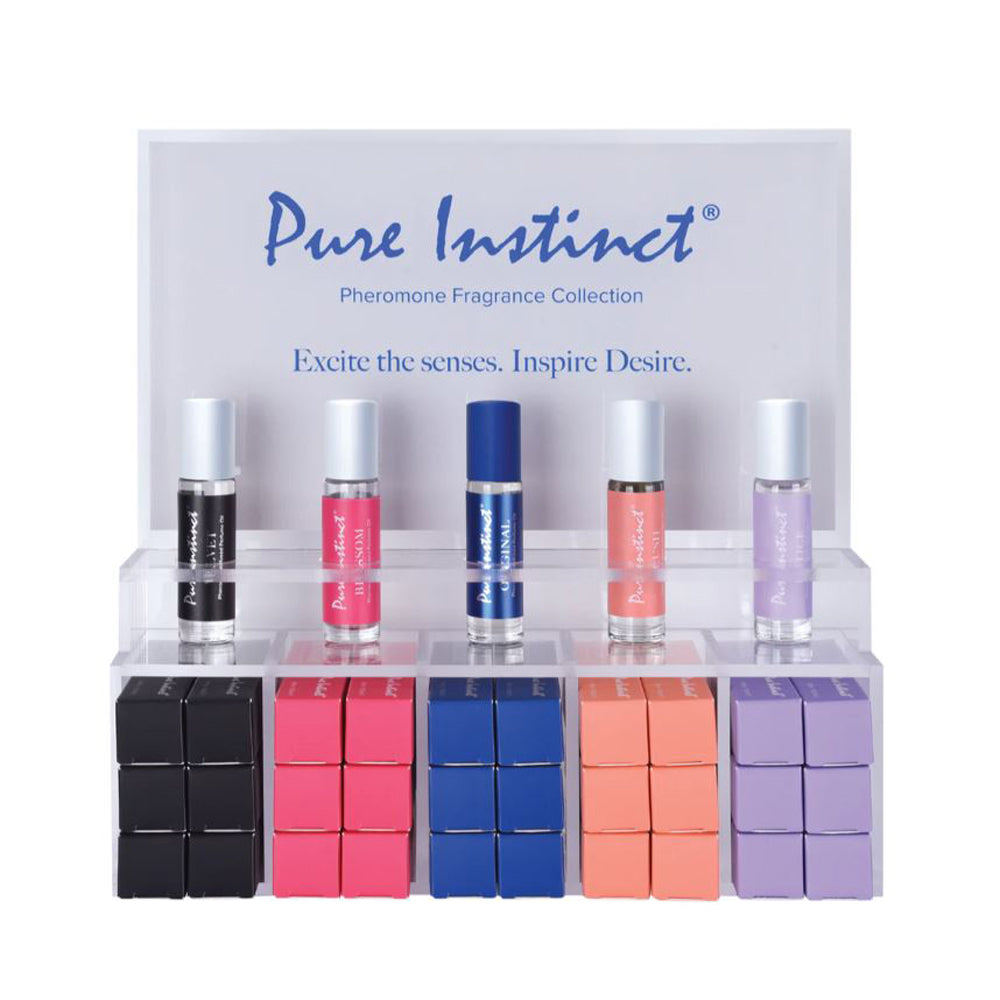 Pure Instinct Pheromone Fragrance Collection display with five rollerball perfumes and boxes.