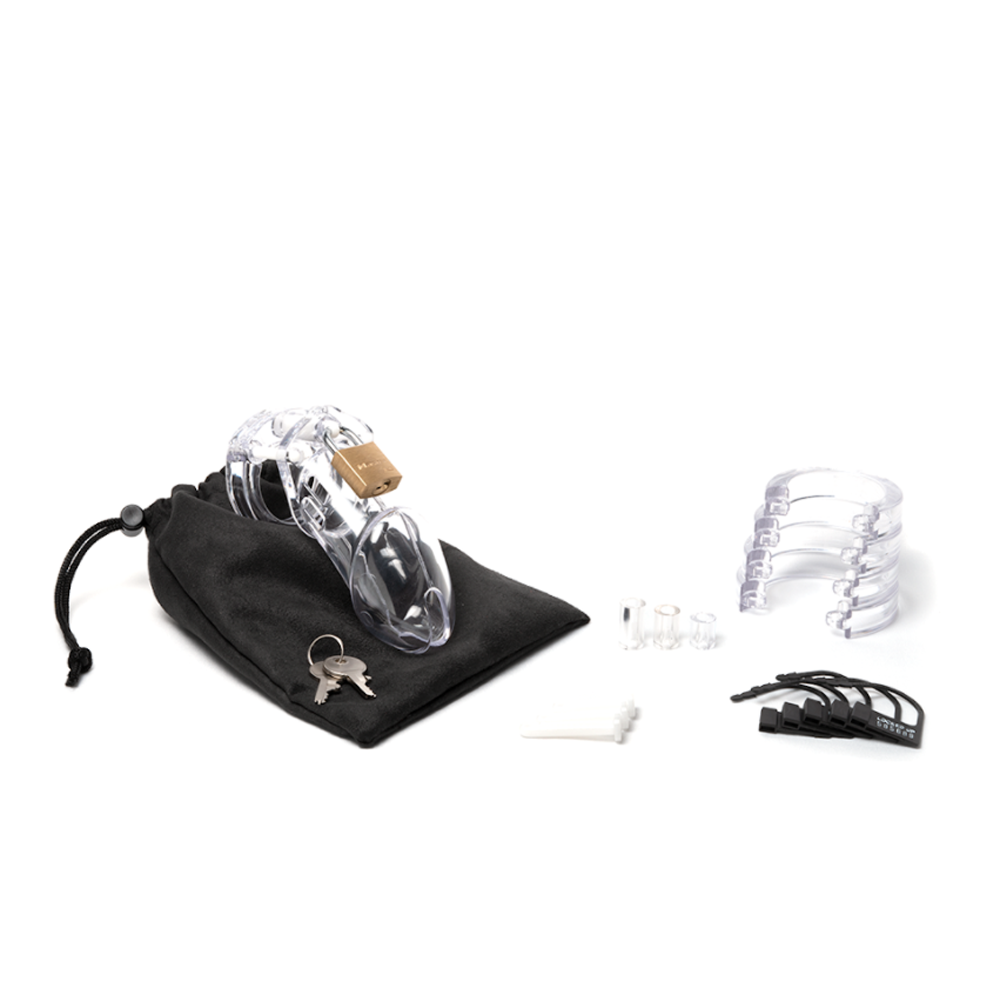 Clear polycarbonate male chastity device kit with accessories.