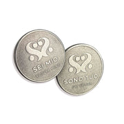 Two stainless steel coins with heart designs and Italian phrases.