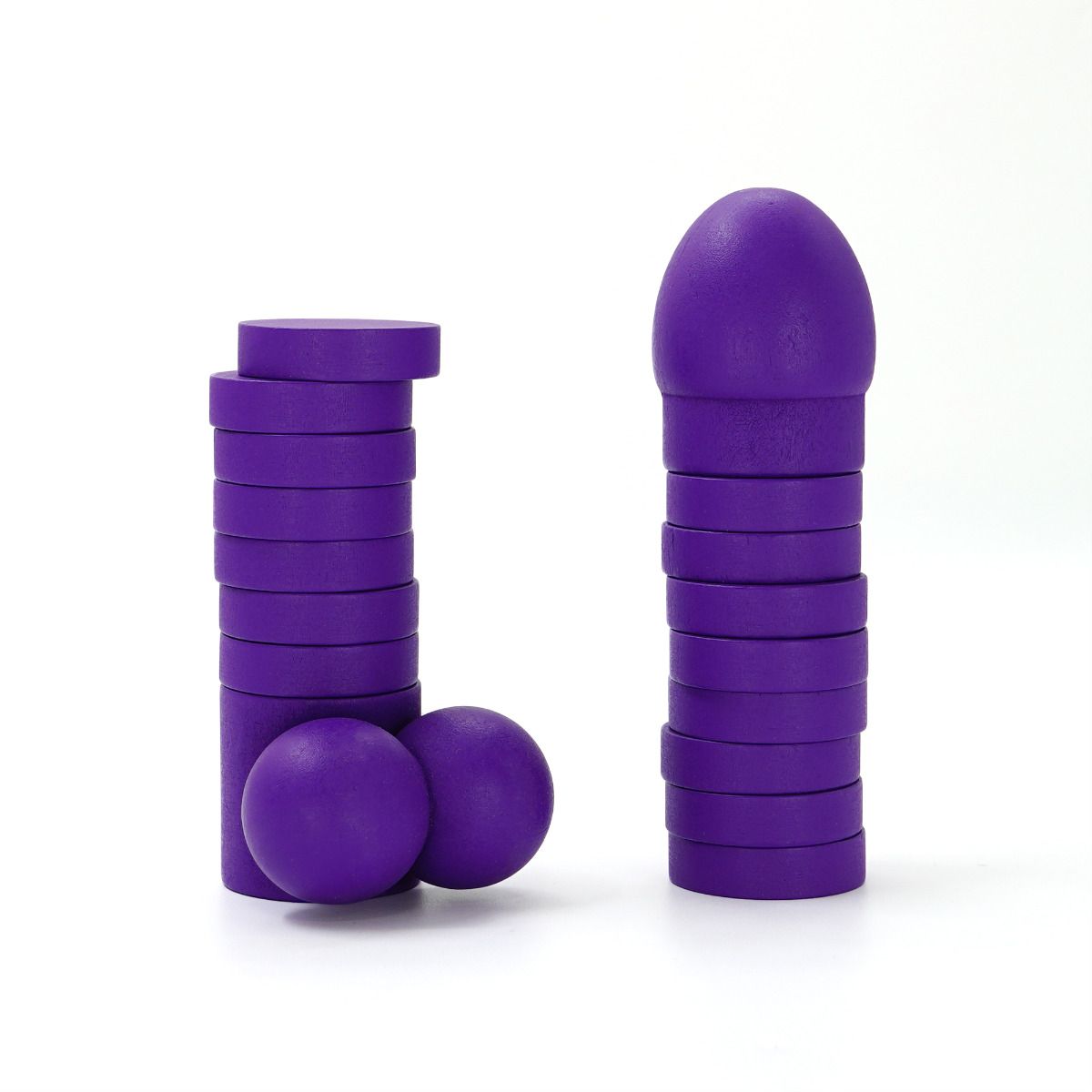 Purple wooden stacking game pieces including discs, balls, and a rounded top.