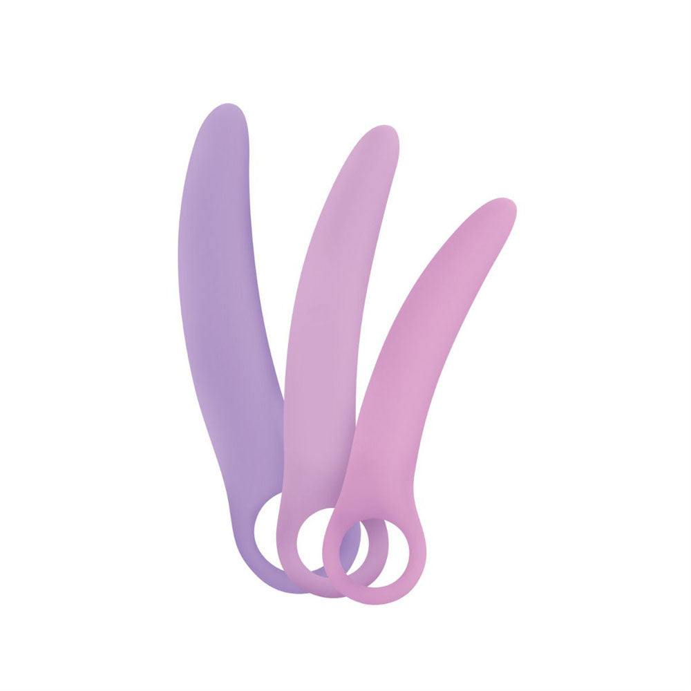 Three curved silicone dilators in purple and pink shades.