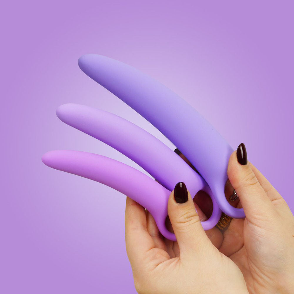 Curved silicone dilator set in three sizes held by hands.