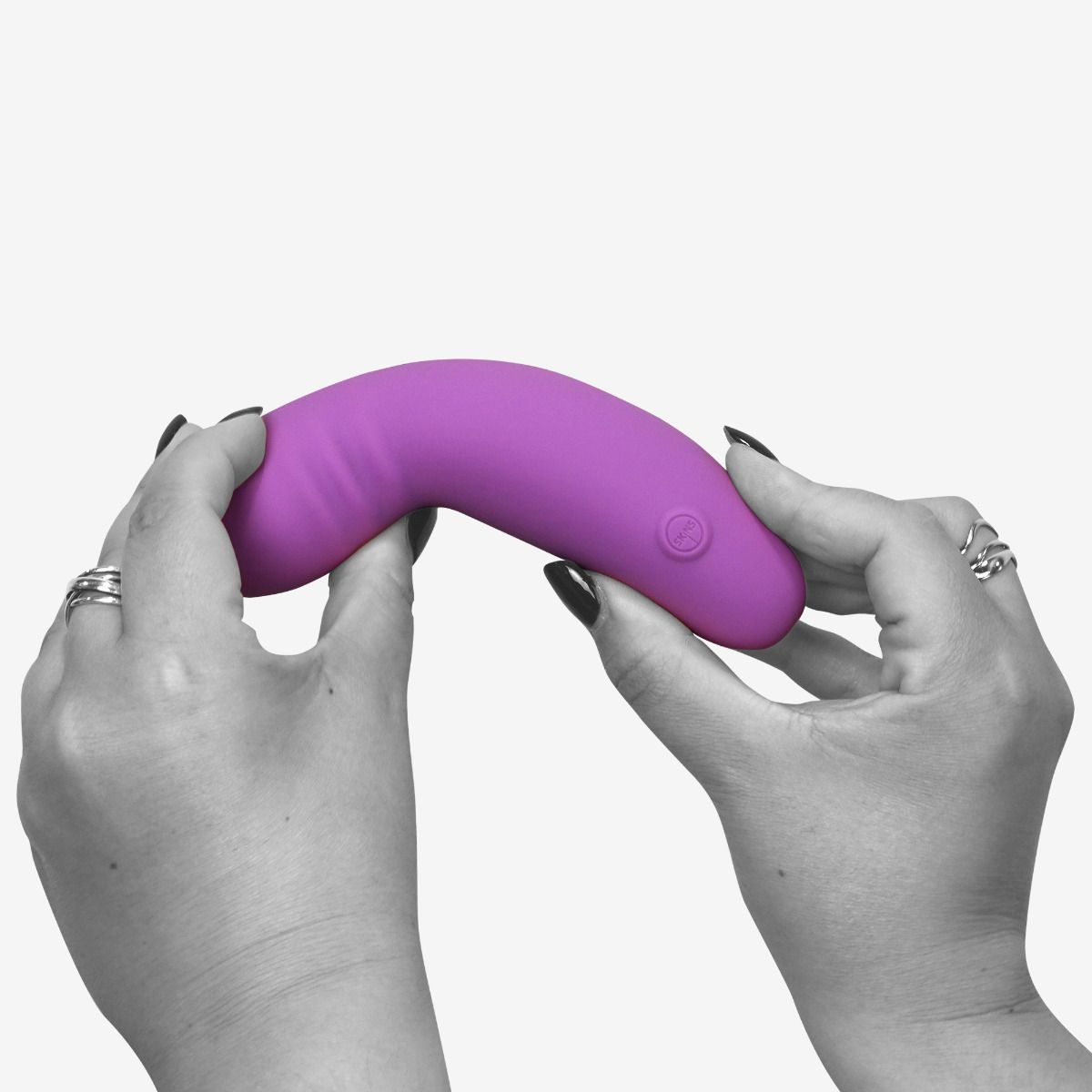 A purple G-spot vibrator held by two hands.