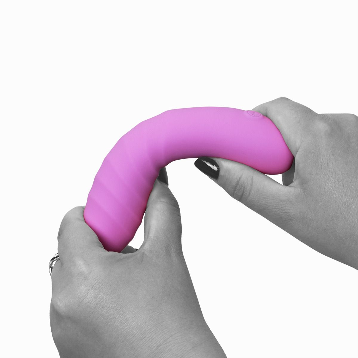Pink curved silicone wand massager with textured grip held by two hands.