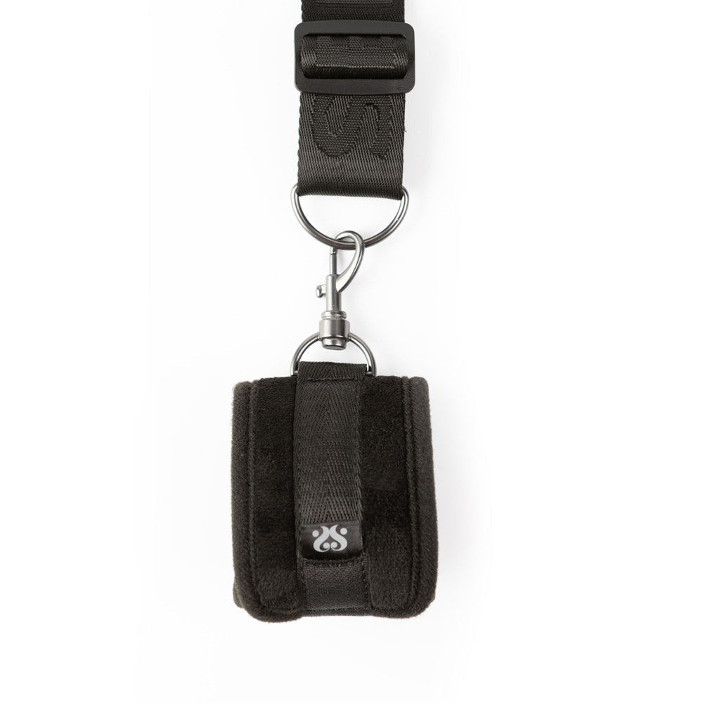 Black padded cuff restraint with adjustable strap and metal hardware.
