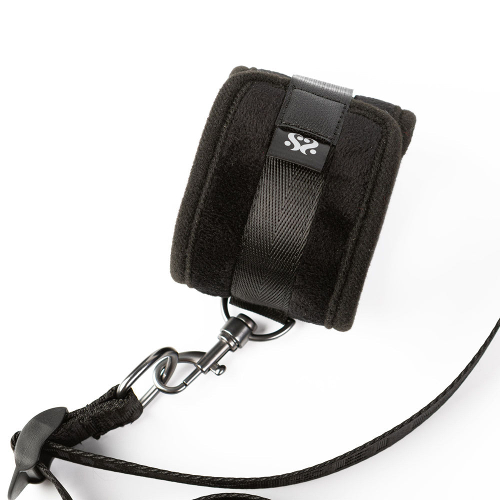 Black padded cuff with strap and metal clip.