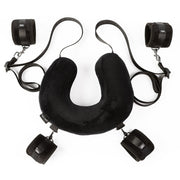 Black padded neck pillow with four wrist cuffs and straps.