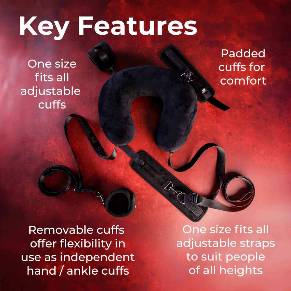 A black sex position restraint system with padded cuffs and adjustable straps.