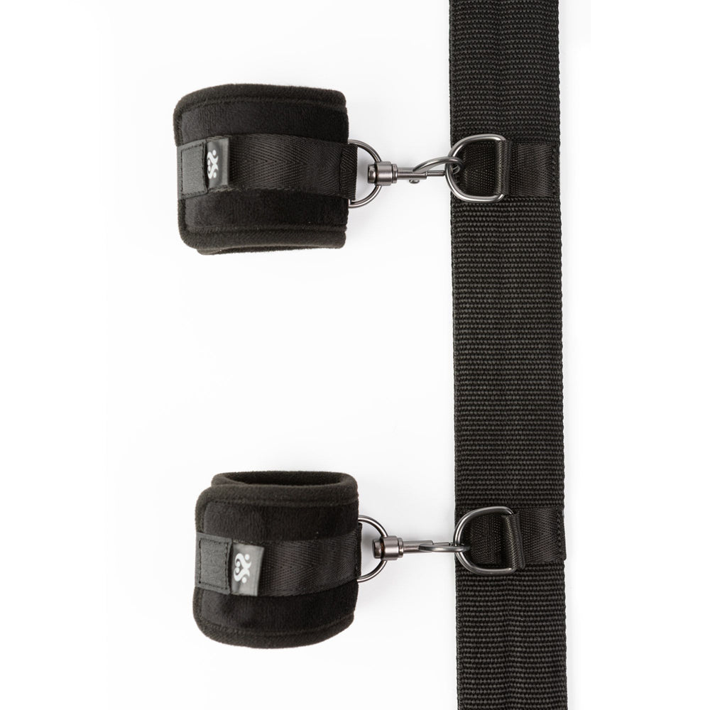 Black velvet wrist cuffs attached to a spreader bar.