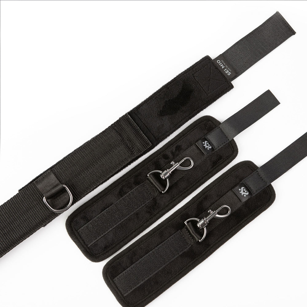 Black velvet ankle spreader bar with wrist cuffs and metal clips.