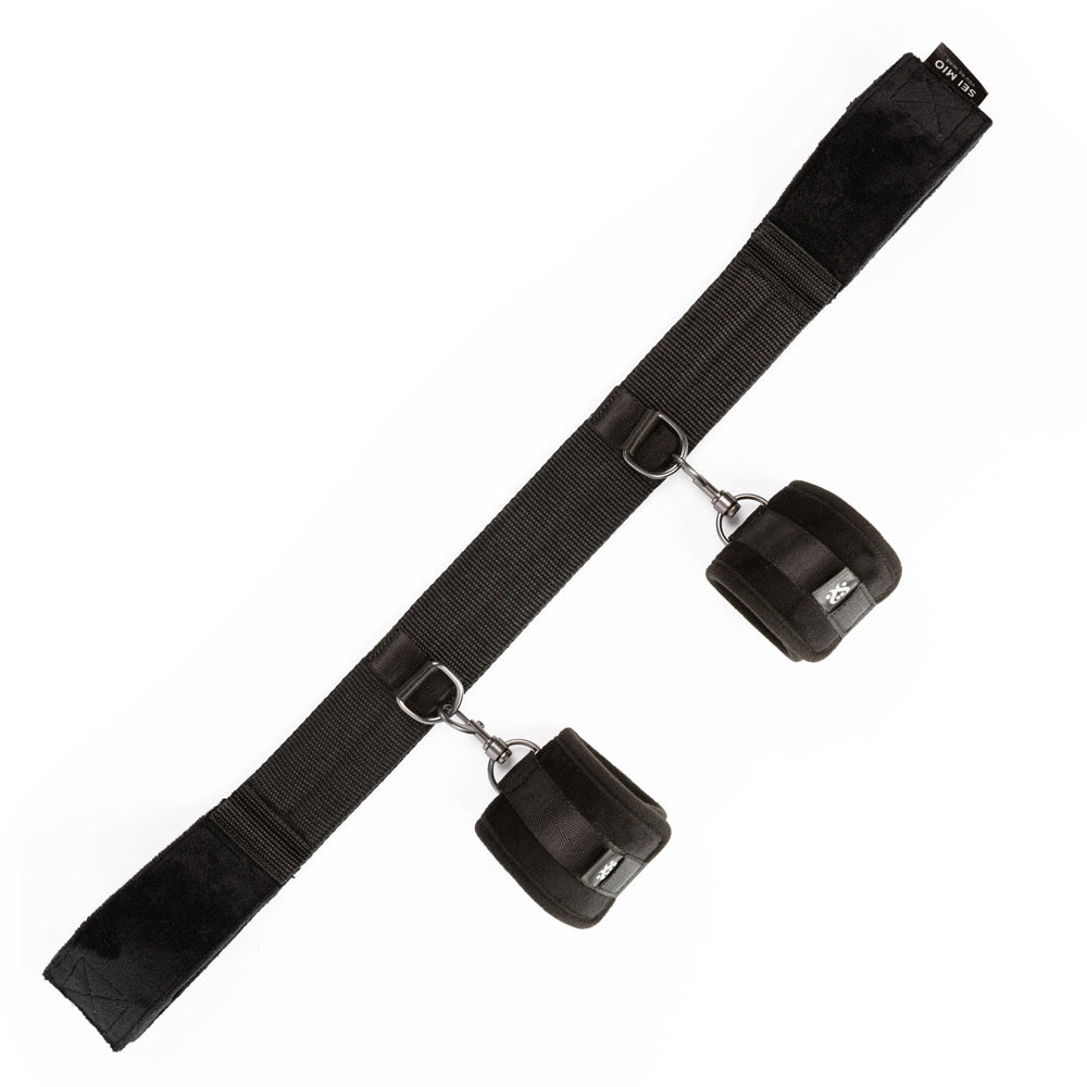 Black ankle spreader bar with velvet wrist cuffs.