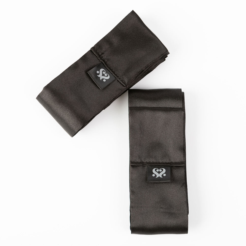 Two black satin silk sash restraints with a logo.