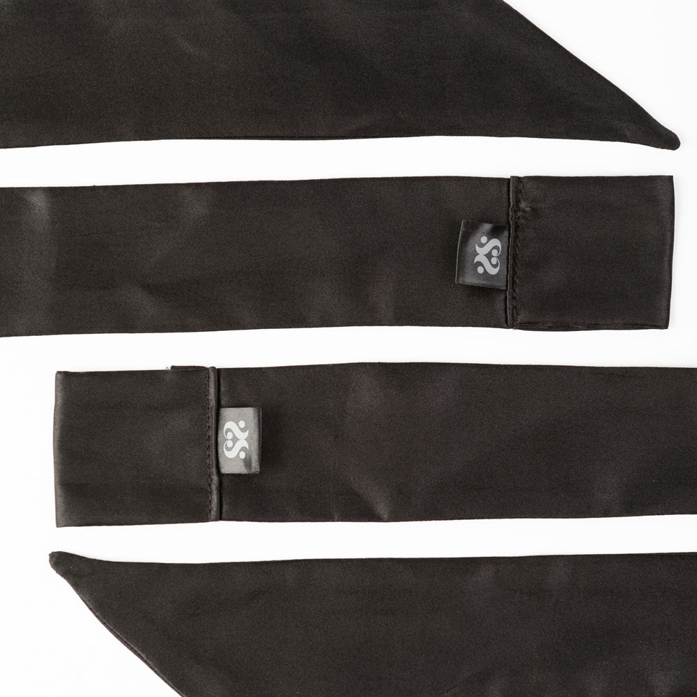 Two black satin silk sash restraints with a grey logo tag.