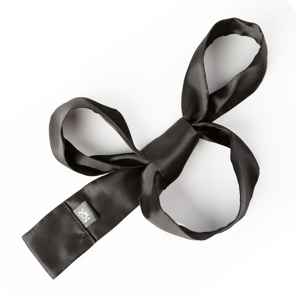 Black satin silk sash restraints tied in a bow with a small tag.