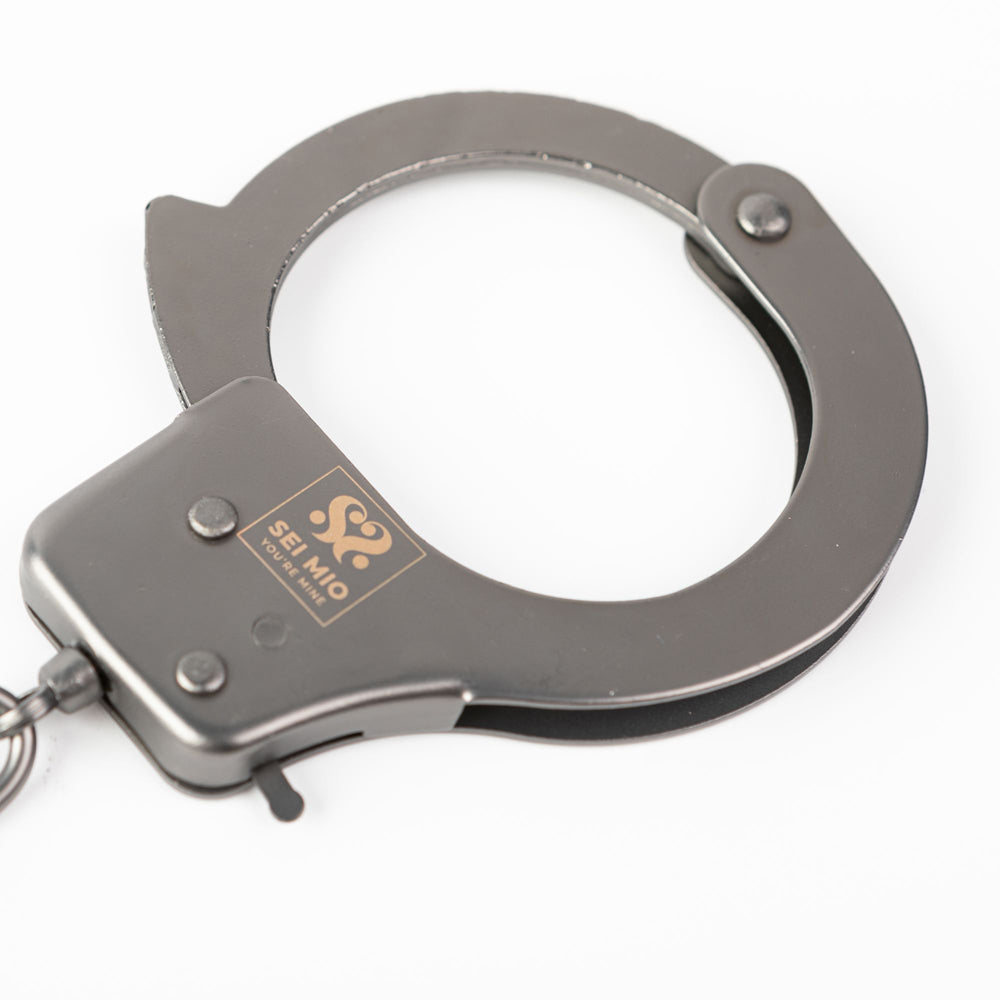 Robust metal handcuffs with a quick release mechanism and the Sei Mio logo.