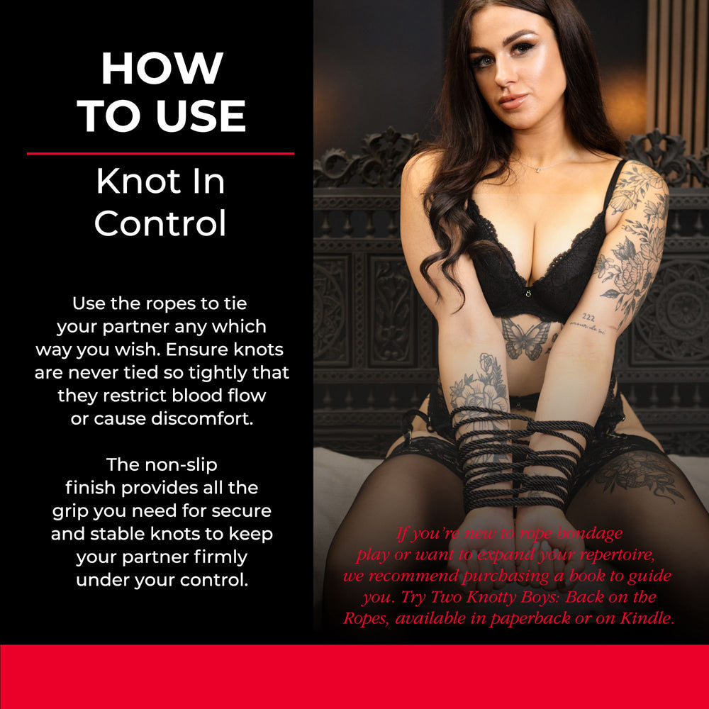 A woman with tattoos is tied with black rope.