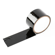 A roll of black, glossy, self-adhering tape with a length of tape unrolled.