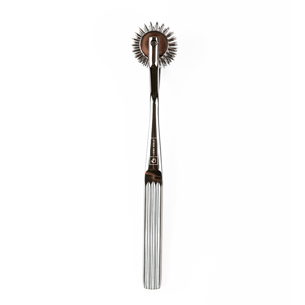 A chrome sensory pinwheel with a textured handle and five rows of pins.