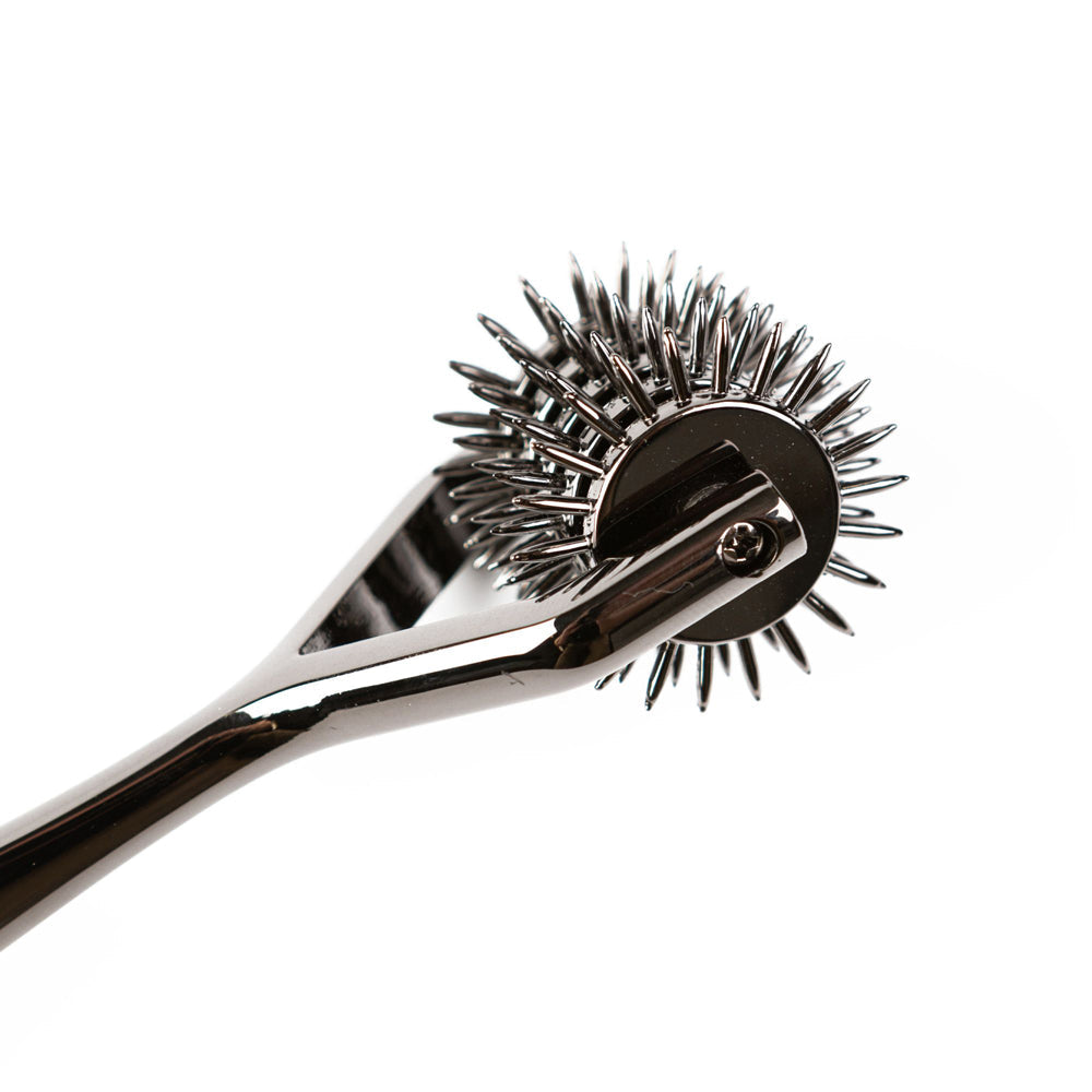 A shiny metal pinwheel with five rows of sharp points on a handle.