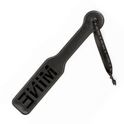 Black faux leather spanking paddle with "MINE" cut out and a wrist strap.