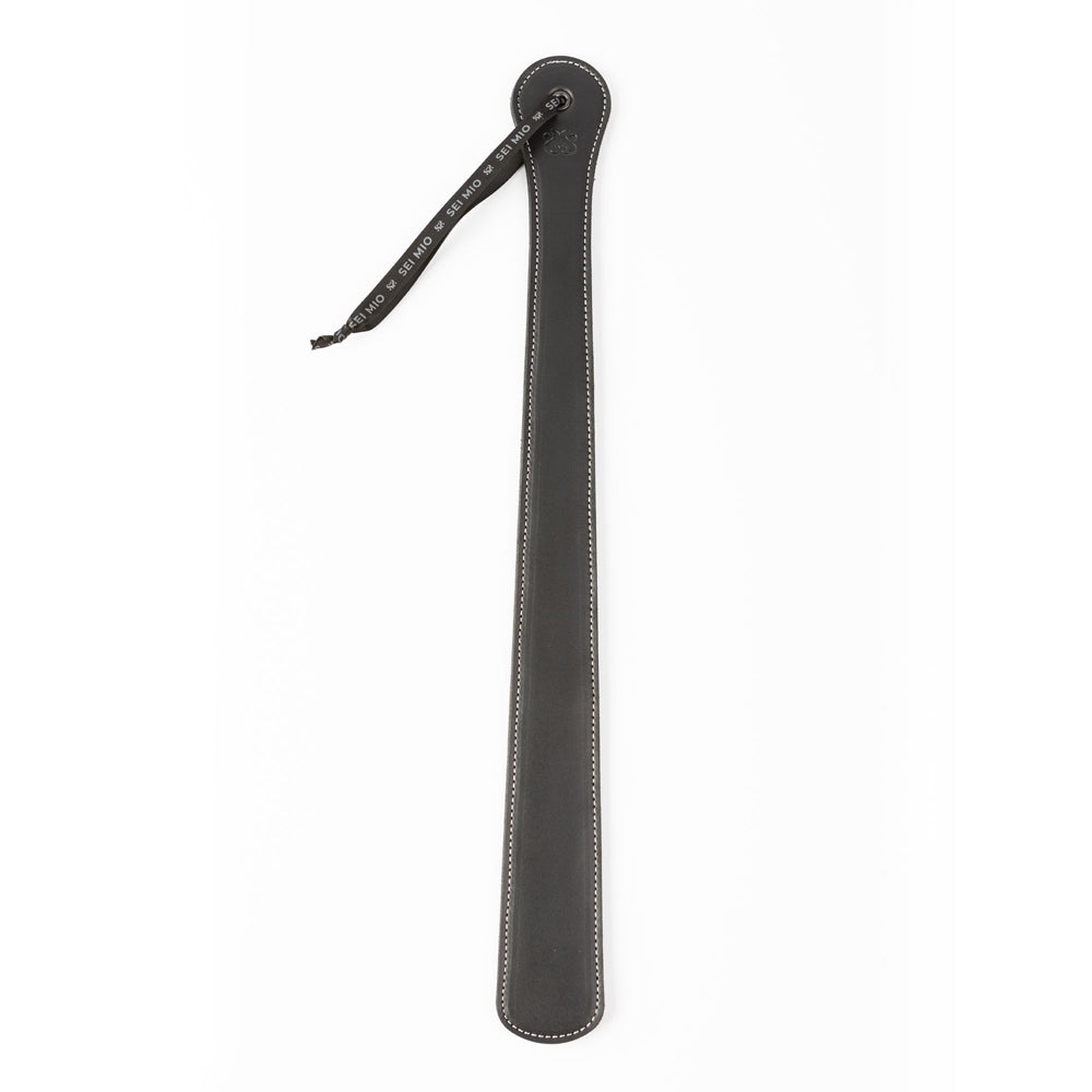A black faux leather spanking paddle with a hanging loop.