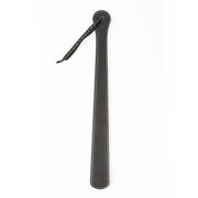 A black faux leather spanking paddle with a hanging loop.