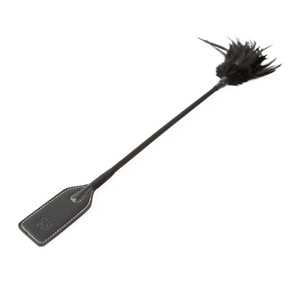 Black riding crop with a feather tickler on one end and a leather paddle on the other.