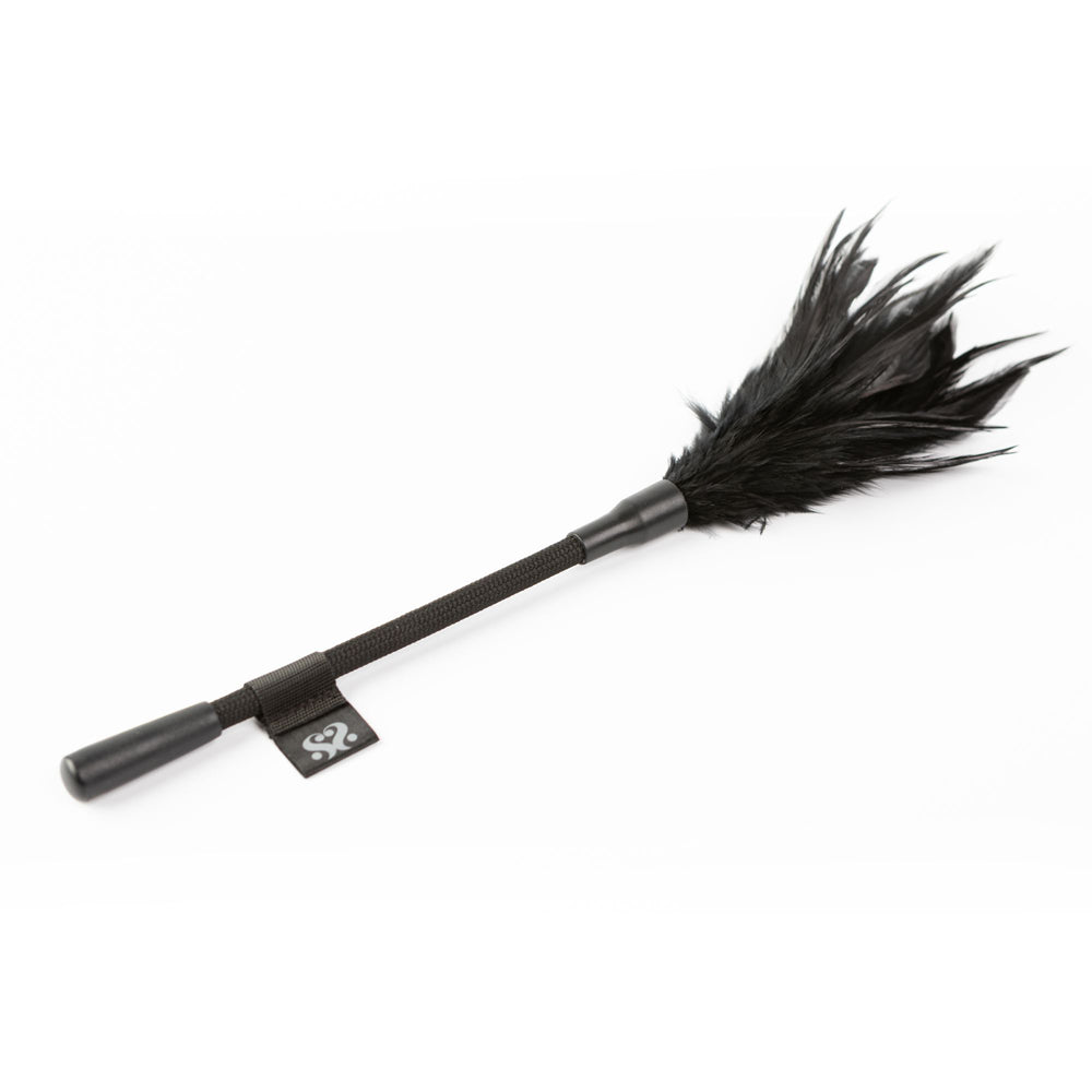 Black feather tickler with a short handle and a fabric strap.