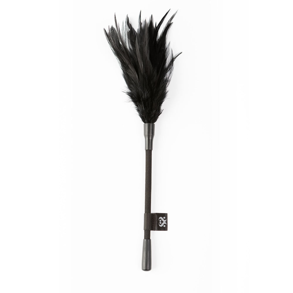 A black feather tickler with a dark handle and a small black tag.