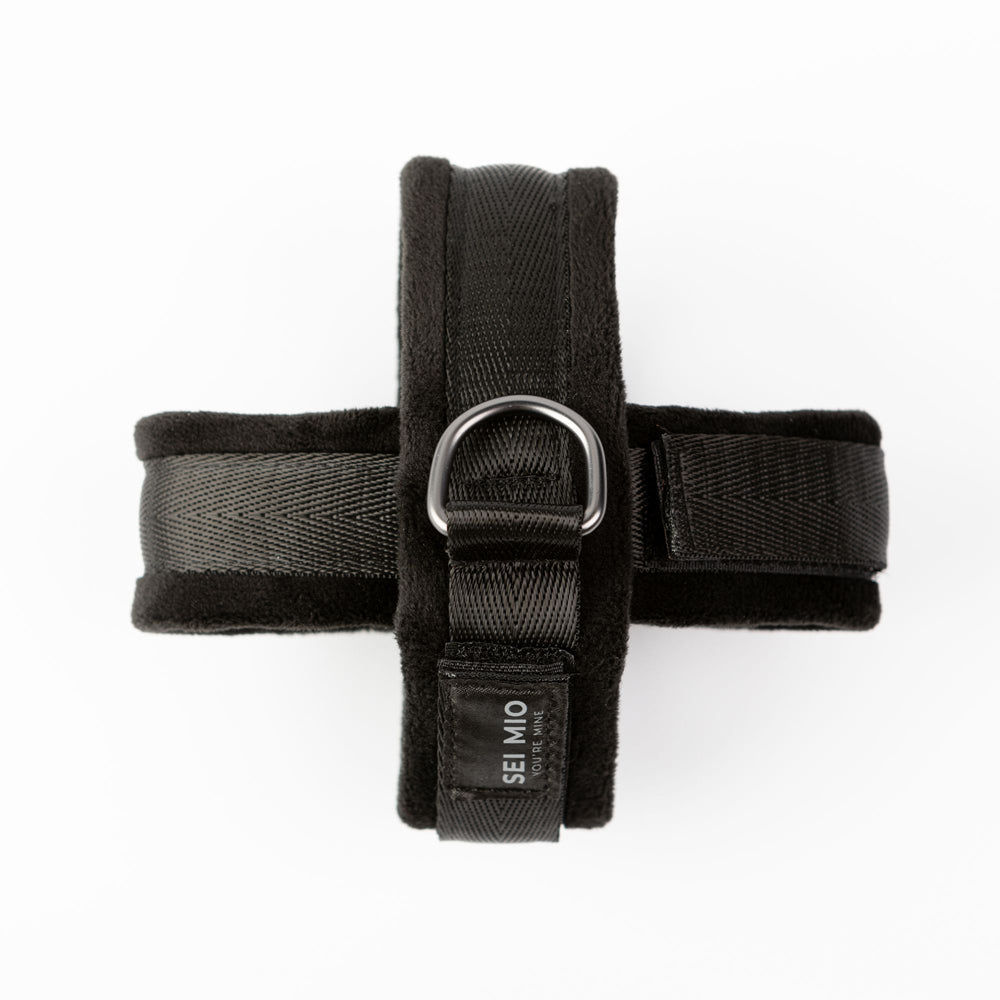 Black velvet wrist cuffs with D-rings and adjustable straps.
