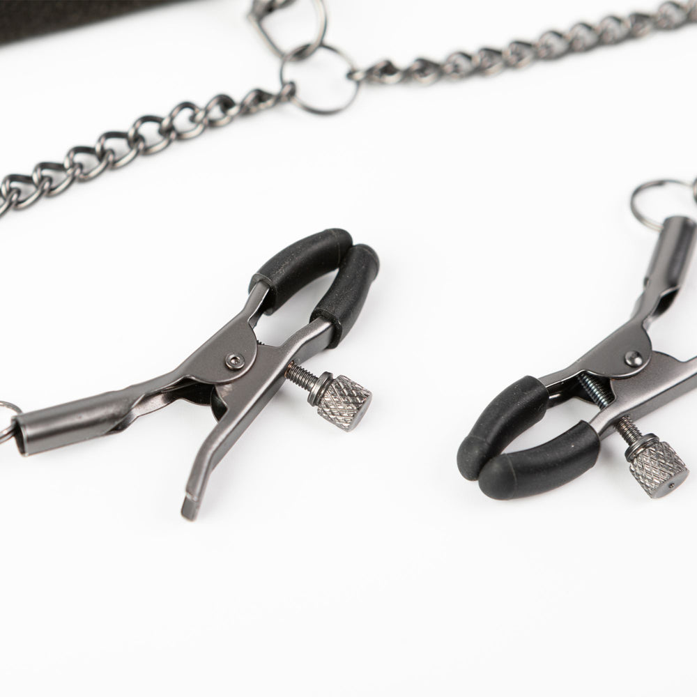 Adjustable metal nipple clamps with black tips and a chain.