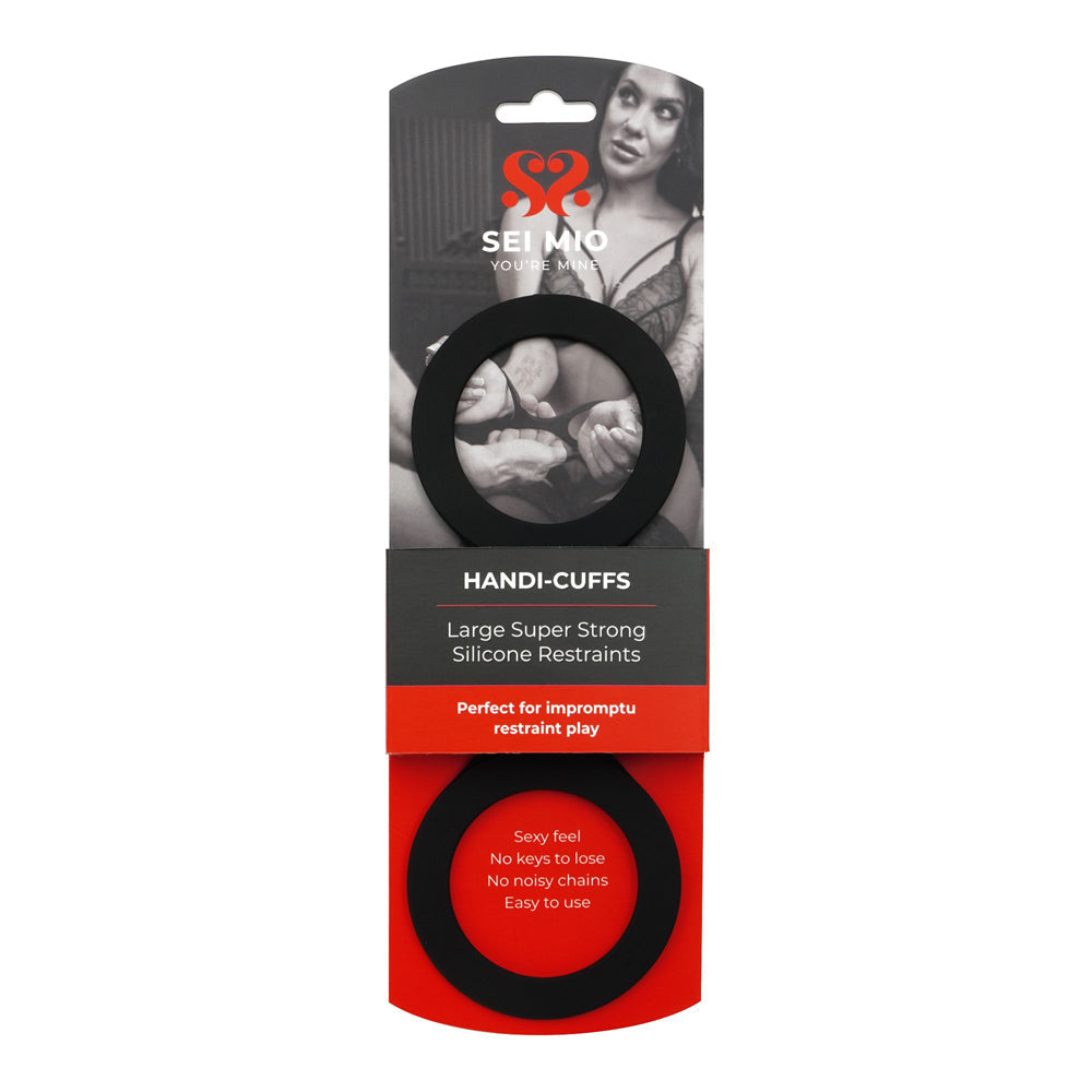 Large black silicone handi-cuffs restraints with product packaging.