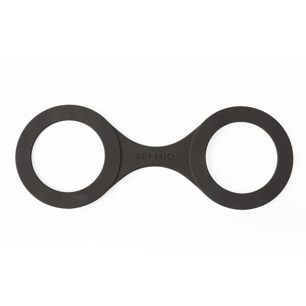 Black silicone hand restraints with "SEI MIO" logo.