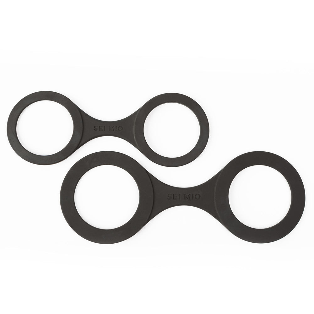 Two black silicone handi-cuffs with "SEI MIO" embossed on them.