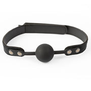 Black silicone ball gag with a velvet strap and metal accents.