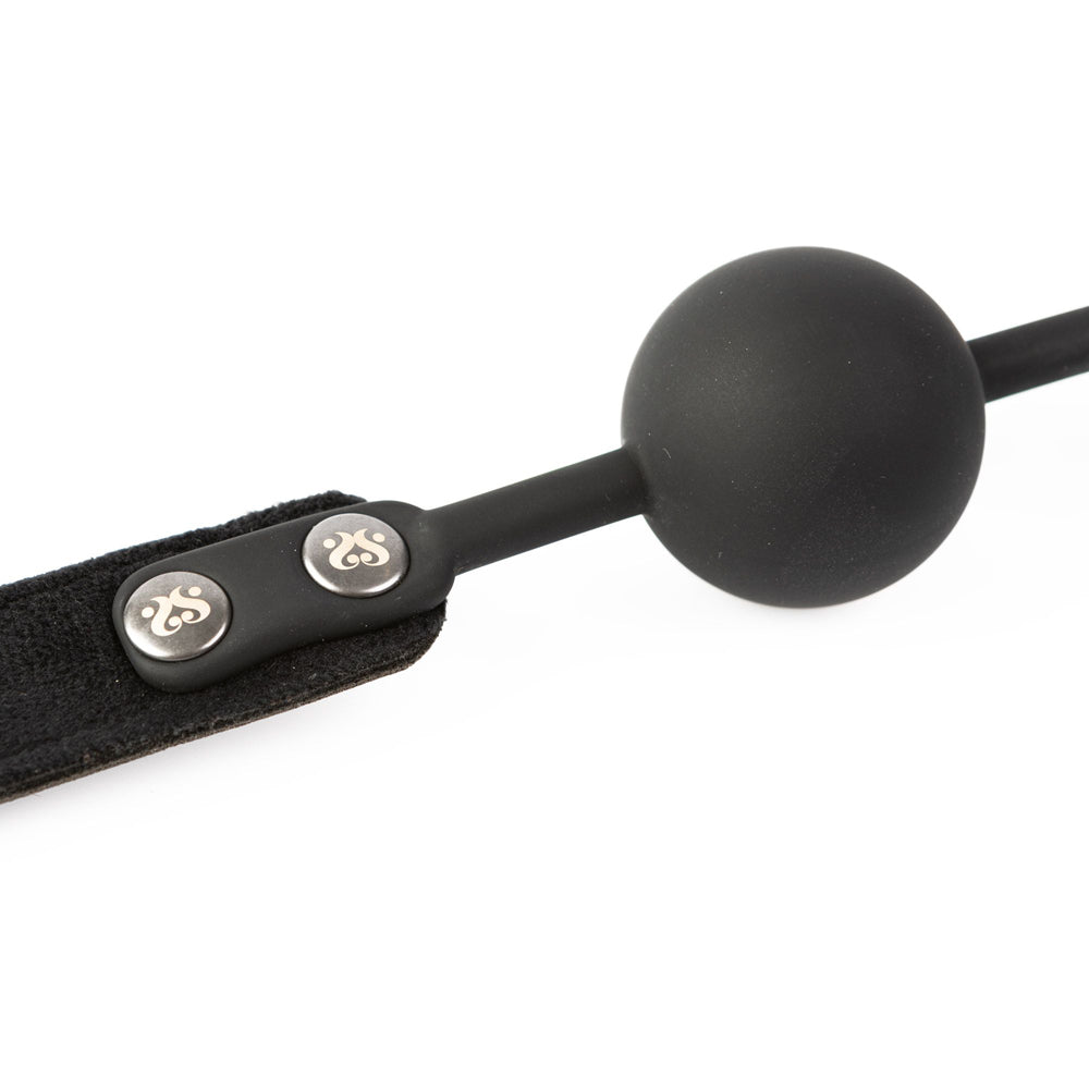 Black silicone ball gag with a velvet strap and two silver snaps.