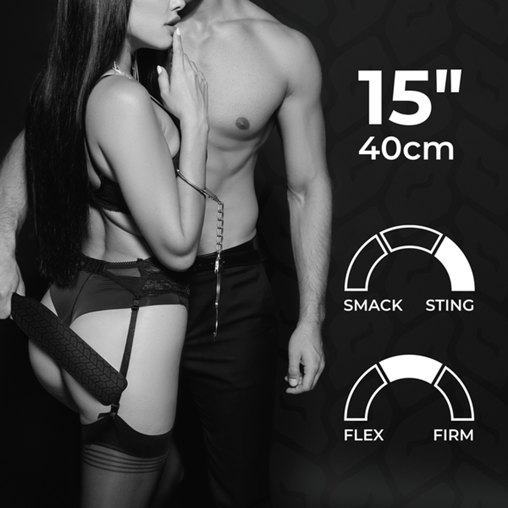 A black and white image of a couple with a silicone spanking paddle.