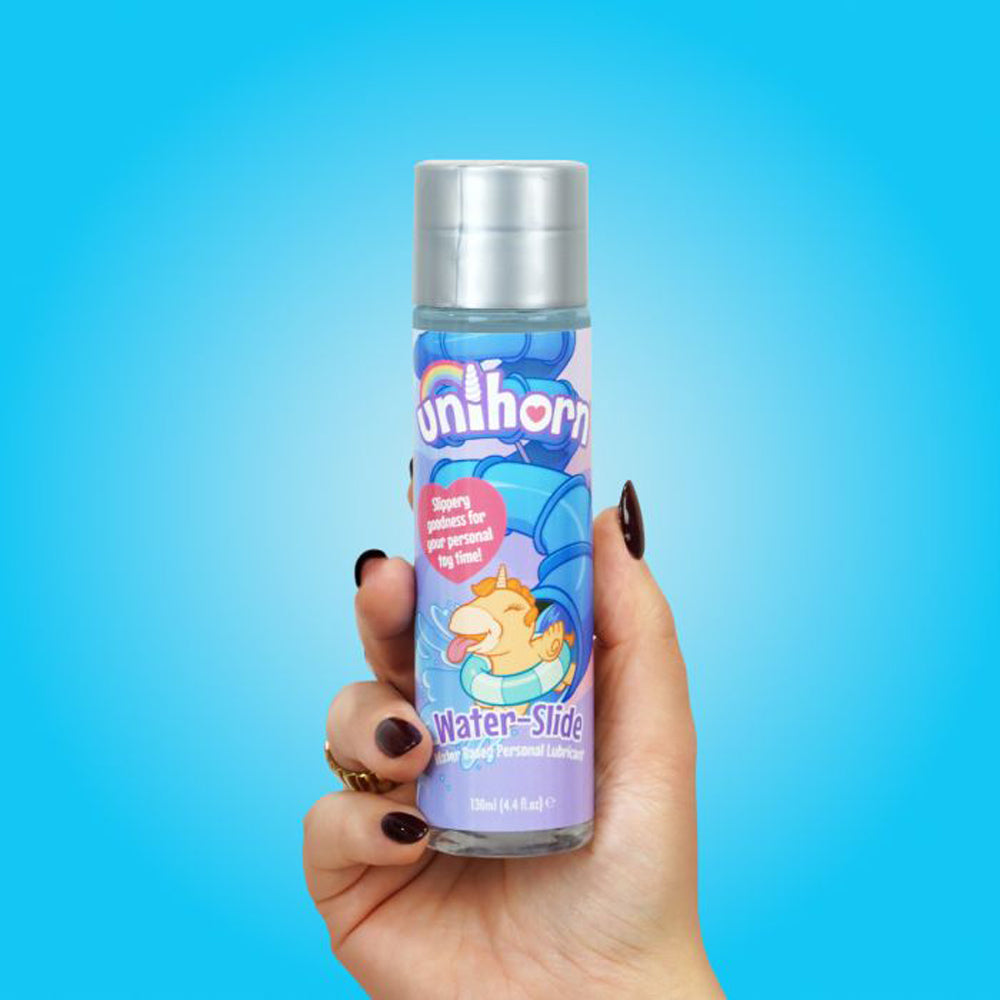 A bottle of Unihorn Water-Slide personal lubricant held in a hand.